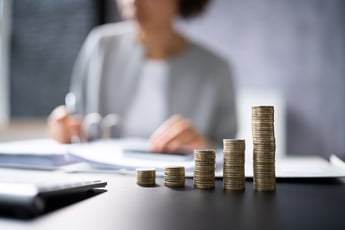 Woman working at desk with money