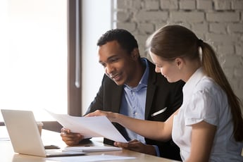 Man and woman looking at work project together