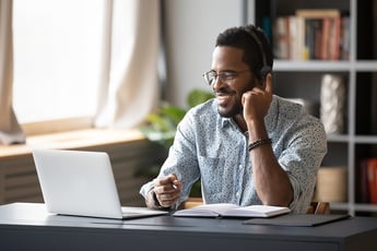 Man teleworking from home on laptop